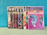 Front view of all nine sleeved comics standing upright, showing Timespirits 1-5 & 7 and Black Canary 2-4