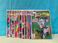 Front view of all eleven bagged comics standing side by side, showing issue numbers and cover art
