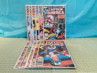 Stack of 11 bagged Captain America comics front and overlapping view