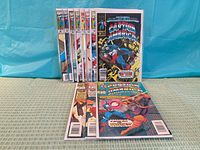 Front view showing all eleven Captain America issues, some standing, some laid flat, in bags and boards
