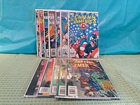 All twelve bagged Captain America comics standing and laying out