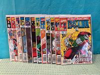 Front view of all twelve bagged Excalibur comic books standing in a row