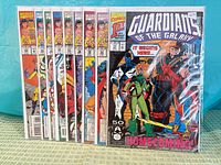 Front view of all nine bagged Guardians of the Galaxy issues standing upright