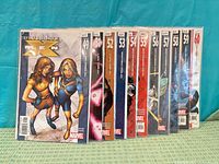 Front view of all eleven bagged issues standing side by side showing spines and cover numbers