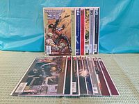 Front view showing upright copies of issues 21-26 and stack of additional comics