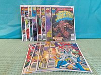 Front view displaying thirteen bagged What If? comics upright and additional comics laid flat