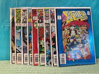 Front view of all nine bagged comics in lot