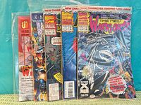 Front view of all five sealed comics and magazine