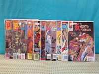Front covers of all eleven comics lined up to show titles and spines