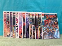 Front view displaying all 13 bagged comics in a row