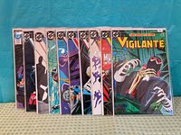 All ten Vigilante comic books upright in sleeves
