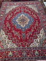 Full view of red Tabriz rug with central medallion