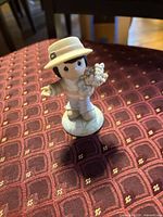 Front view of porcelain boy figurine on patterned surface