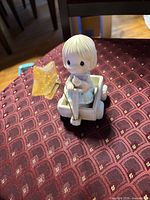 Front view of Precious Moments figurine on wagon