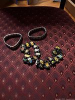 Five stretch religious charm bracelets laid out on chair