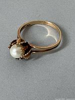 Full view of ring showing band, setting and pearl