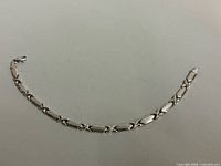 Full view of bracelet laid flat showing link pattern and clasp