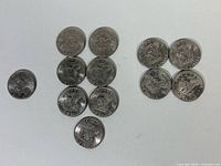 All 12 Eisenhower dollars arranged by year groups