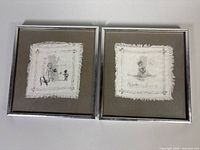 Both framed fabric artworks side by side for scale and overview