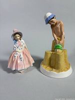 Both figurines side by side showing comparative size and design details