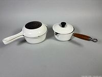 Both saucepans with lids displayed, size comparison, showing handles and lid tops