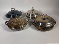 Four covered casserole dishes grouped