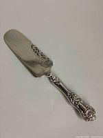 Full view of Birks sterling pie cutter showing blade and handle