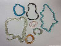 Group shot showing all four necklaces and three bracelets