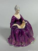Front angled view showing full figurine, gown color, cat detail