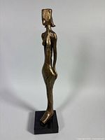 Full view left side of resin female figurine on base