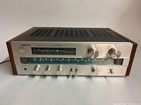 Front angled view of Sony STR-V2 receiver showing overall condition, controls and display