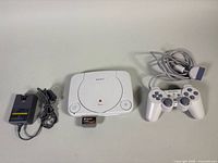 Console, controller, power adapter and memory card laid out