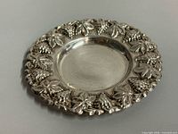 Full view of sterling tray showing grapevine rim and center surface