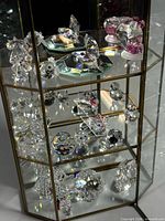 Cabinet with all crystal figures displayed across three tiers
