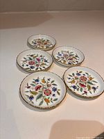 Five porcelain coasters displayed face up