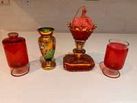 Group shot of four red glass decorative items