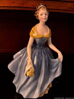 Front of Royal Doulton Melanie figurine showing gown, pose and bouquet
