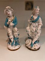 Front view of both porcelain figurines showing color, pose and condition