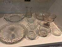 All 11 clear pressed-glass serving pieces grouped together
