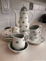 Full set arranged showing pot, cups, saucers, creamer, sugar bowl