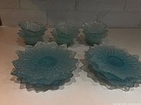 all six turquoise pressed glass dishes displayed; shows starburst design and scalloped rims