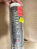 Front of sealed Arthouse wallpaper roll showing brand logo
