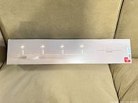 Front of retail box showing Globe 4-light vanity light