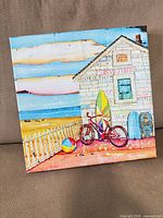 Front view of square canvas showing beach cottage scene