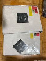 Two sealed packages of white Lauren Ralph Lauren curtain panels