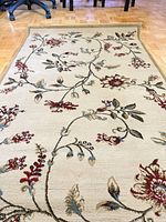Full view of rug showing floral pattern and colors