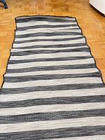 Full view of striped runner laid flat showing color and pattern