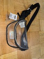 Full view of clear iridescent Vans fanny pack showing main compartment and strap