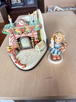 Front view showing fireplace base and separate child figurine
