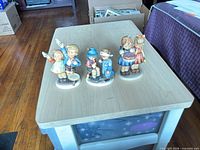 Front view showing all three figurines on table